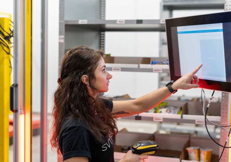 Woman on touch screen with scanner in hand